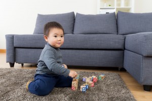 image of boy playing on rug for Sydney residential rug cleaning service from carpet cleaning authority
