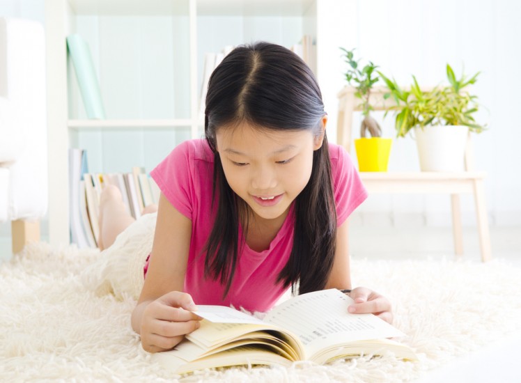 image of girl reading on carpet for header image for residential carpet cleaning service from carpet cleaning authority